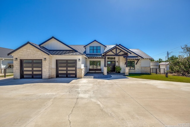 112 Chinkapin, Boerne, TX 78006 - modern farmhouse with stone siding, metal roof, a garage, concrete driveway, and a standing seam roof