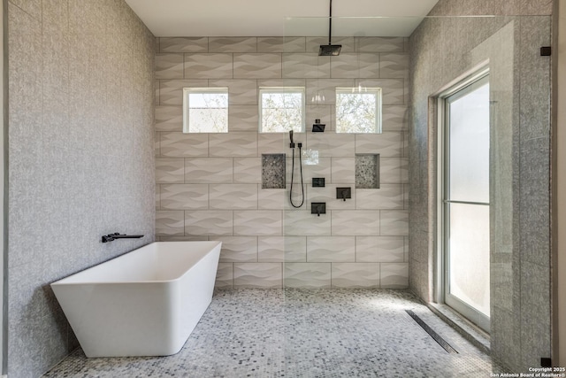 112 Chinkapin, Boerne, TX 78006 - bathroom featuring a freestanding bath, tile walls, and a walk in shower