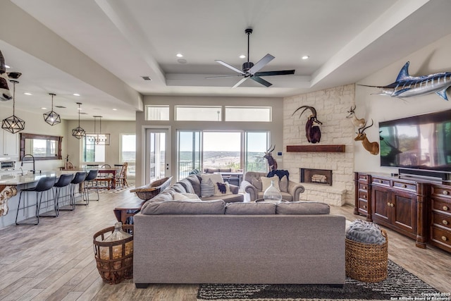 112 Chinkapin, Boerne, TX 78006 - living area featuring light wood finished floors, ceiling fan, and a raised ceiling