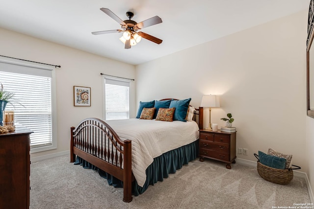 carpeted bedroom featuring baseboards and ceiling fan