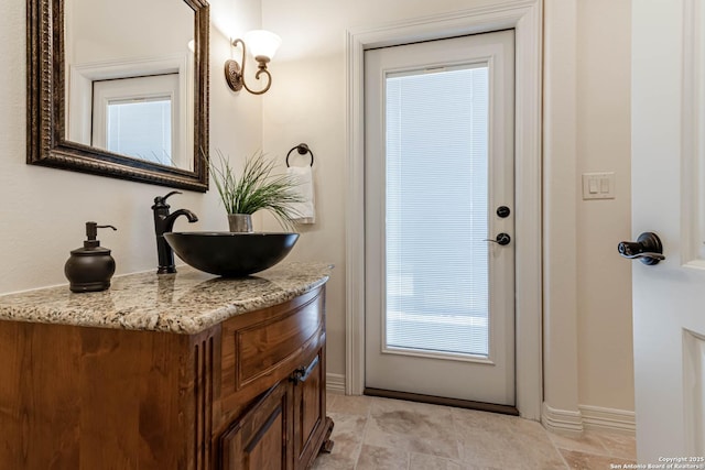 bathroom with baseboards and vanity