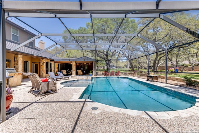 view of pool with a patio area, a pool with connected hot tub, and a lanai