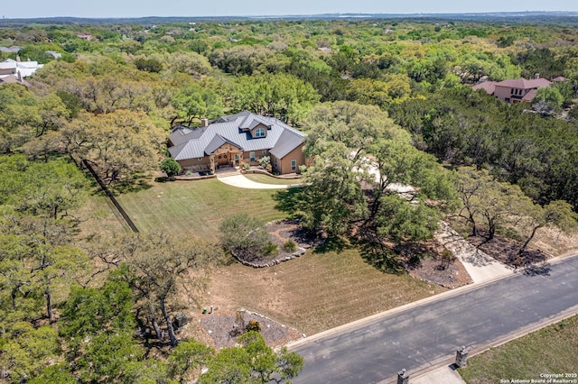 drone / aerial view featuring a forest view