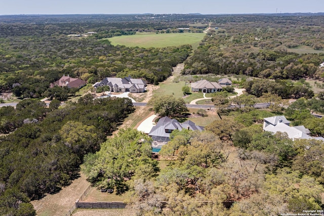 drone / aerial view featuring a view of trees