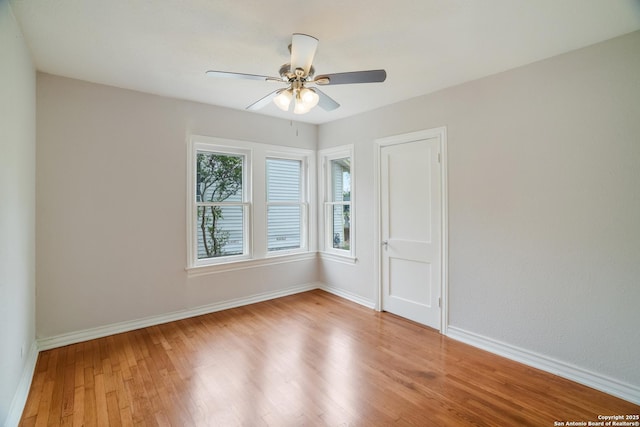 unfurnished room with light wood-style flooring, baseboards, and a ceiling fan