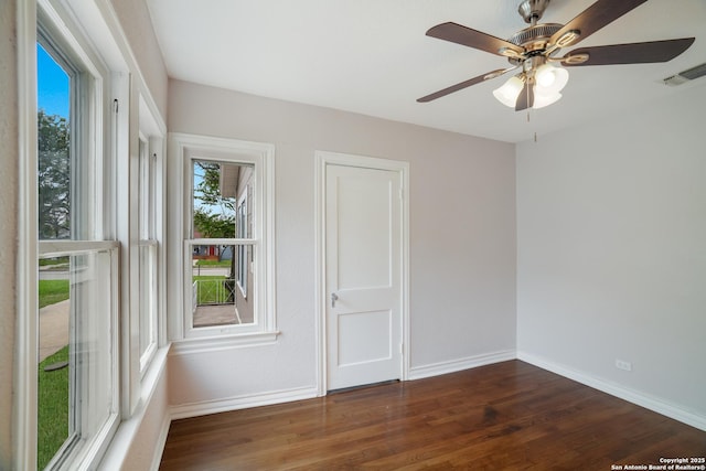 spare room with visible vents, baseboards, ceiling fan, and wood finished floors