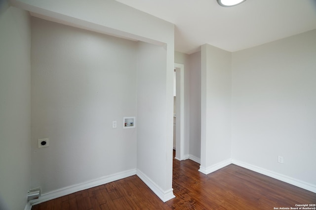empty room featuring baseboards and dark wood-style floors