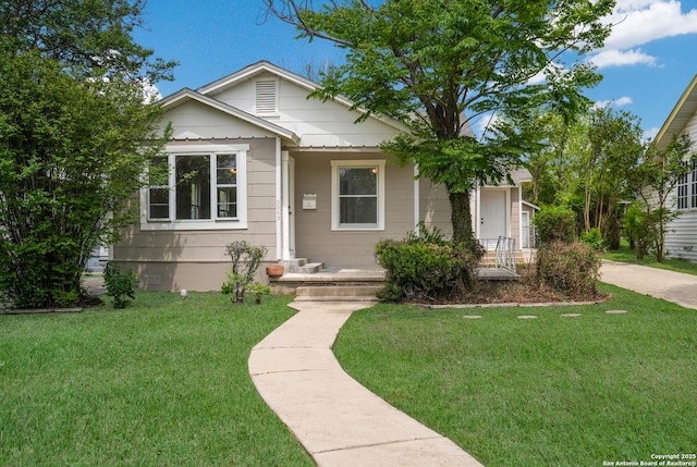 bungalow-style house featuring a front yard
