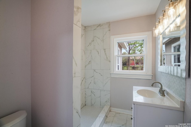 full bath with vanity, toilet, marble finish floor, a marble finish shower, and baseboards