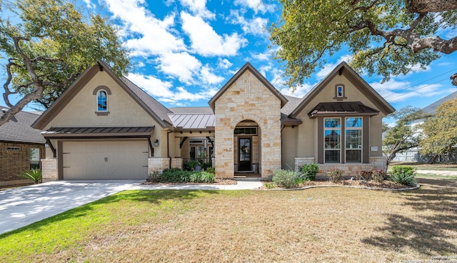 view of front of property with a standing seam roof, stucco siding, metal roof, stone siding, and concrete driveway