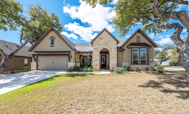 view of front of house with stucco siding, driveway, stone siding, a standing seam roof, and metal roof