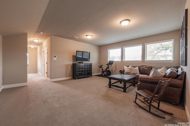 living area with light carpet, baseboards, visible vents, and a textured ceiling