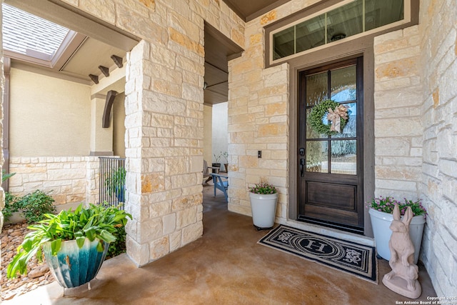 doorway to property with stone siding and covered porch