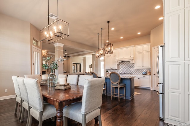 dining area with recessed lighting, dark wood-type flooring, visible vents, and baseboards