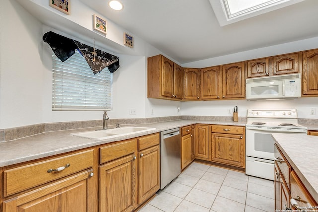 10 Oakwell Farms Pkwy, San Antonio, TX 78218 - kitchen with a sink, light tile patterned floors, brown cabinetry, and white appliances