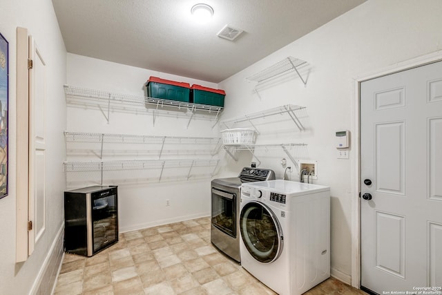 10 Oakwell Farms Pkwy, San Antonio, TX 78218 - washroom with laundry area, visible vents, beverage cooler, baseboards, and washing machine and dryer