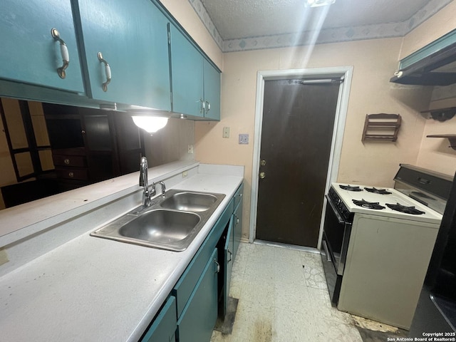 kitchen with a sink, light countertops, white gas stove, blue cabinetry, and light floors