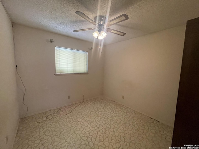 carpeted spare room with a textured ceiling and ceiling fan