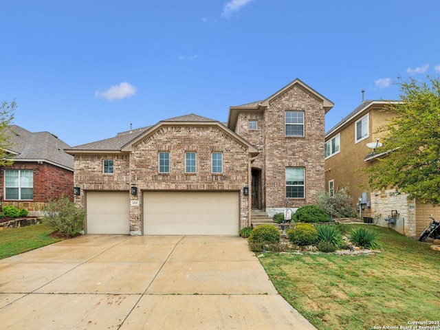 view of front of property featuring an attached garage, concrete driveway, a front lawn, and brick siding