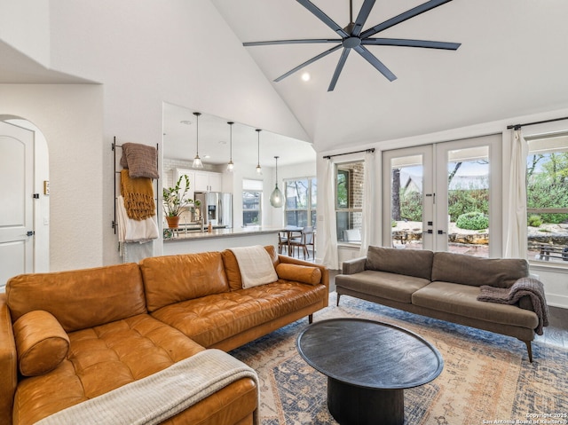 living area featuring recessed lighting, french doors, a ceiling fan, high vaulted ceiling, and arched walkways
