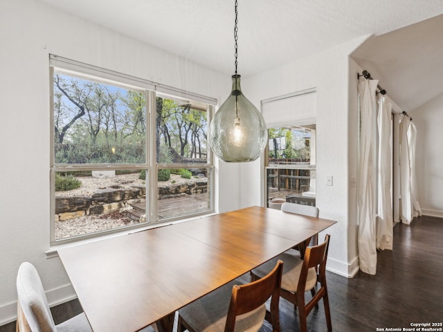 dining area featuring baseboards and wood finished floors