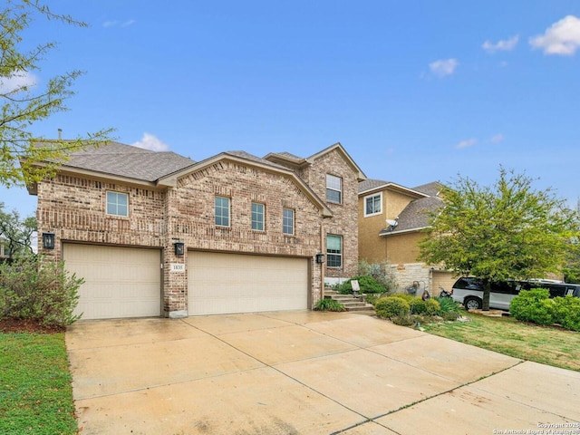 traditional home with an attached garage, roof with shingles, concrete driveway, and brick siding