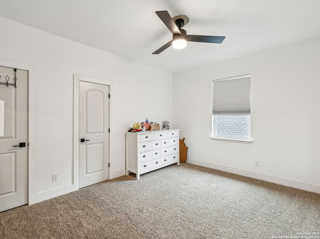 unfurnished bedroom with carpet, baseboards, and ceiling fan