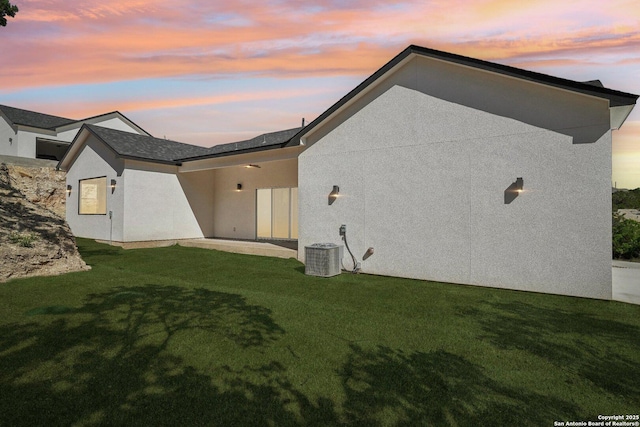 174 Magnolia Mdw, Canyon Lake, TX 78133 - rear view of property featuring a yard, stucco siding, and central AC