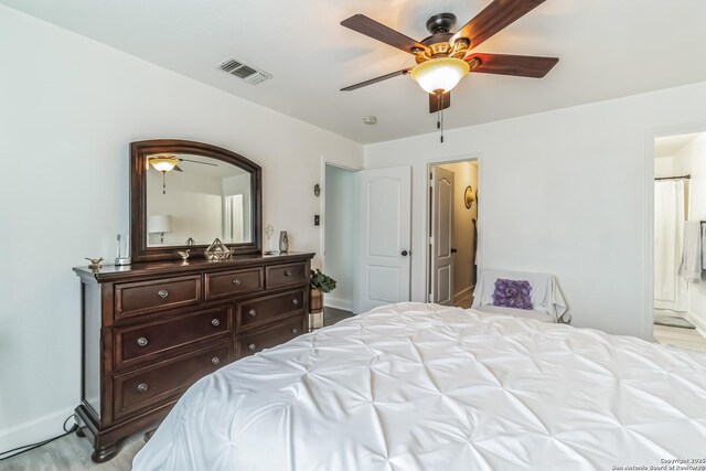 bedroom featuring ensuite bathroom, baseboards, a ceiling fan, and visible vents