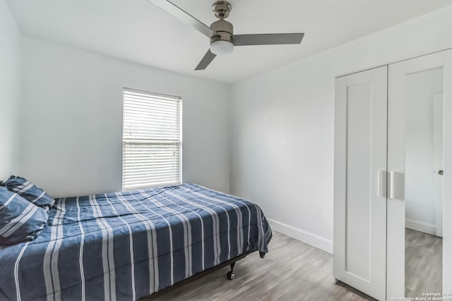 bedroom with wood finished floors, ceiling fan, and baseboards