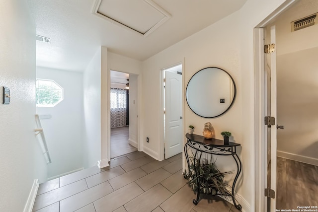 interior space with attic access, baseboards, and visible vents
