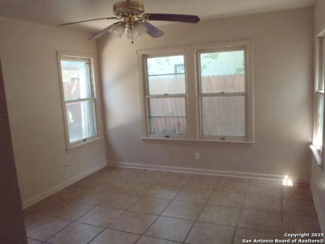 335 Hot Wls, San Antonio, TX 78223 - spare room featuring a wealth of natural light, ceiling fan, light tile patterned floors, and baseboards