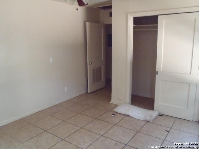 335 Hot Wls, San Antonio, TX 78223 - unfurnished bedroom with light tile patterned flooring, visible vents, baseboards, and a closet