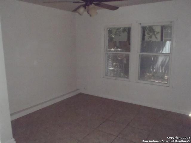 335 Hot Wls, San Antonio, TX 78223 - empty room with tile patterned floors, ceiling fan, and baseboards