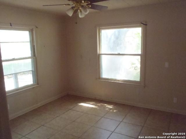 335 Hot Wls, San Antonio, TX 78223 - empty room with baseboards, ceiling fan, and light tile patterned flooring