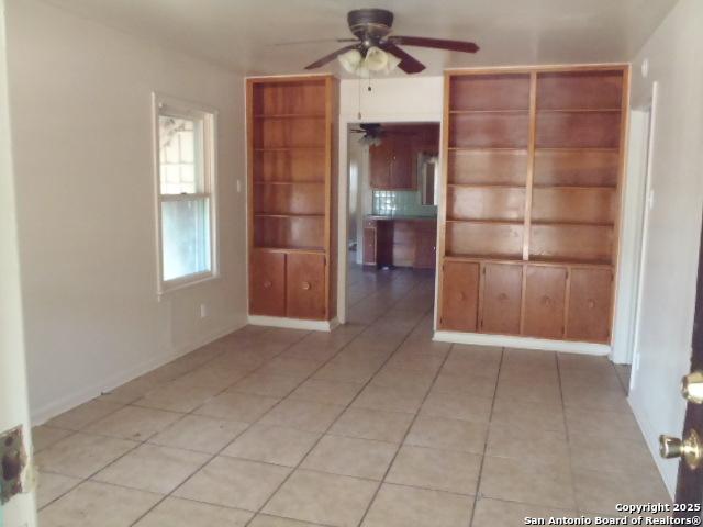 335 Hot Wls, San Antonio, TX 78223 - unfurnished room with baseboards, light tile patterned floors, and ceiling fan