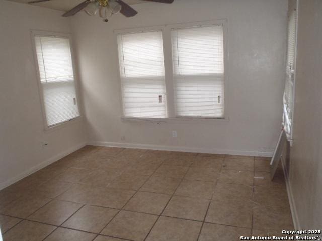 335 Hot Wls, San Antonio, TX 78223 - empty room featuring light tile patterned floors, ceiling fan, baseboards, and a healthy amount of sunlight