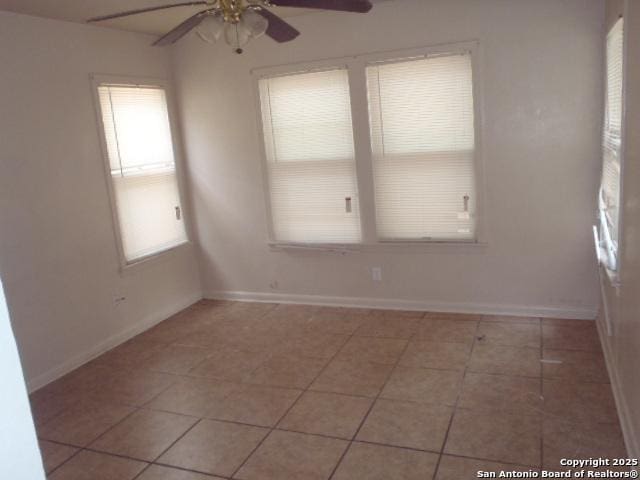 335 Hot Wls, San Antonio, TX 78223 - spare room with tile patterned floors, baseboards, and ceiling fan
