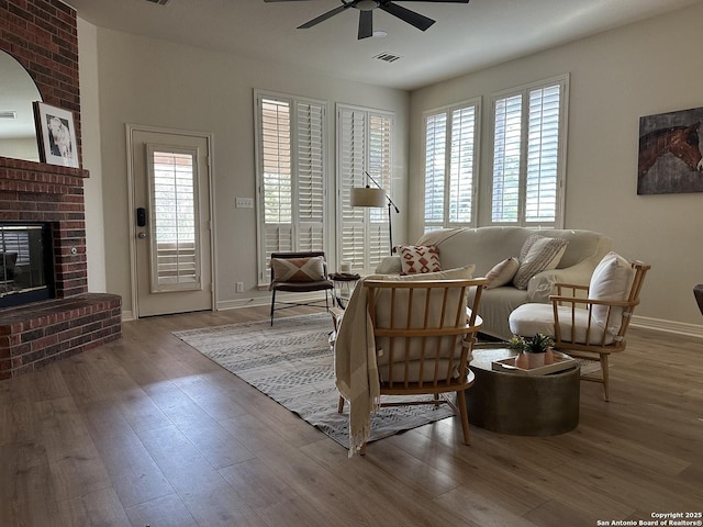 23407 Treemont Park, San Antonio, TX 78261 - living room with ceiling fan, a brick fireplace, and wood finished floors