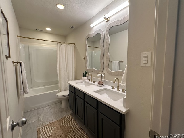 23407 Treemont Park, San Antonio, TX 78261 - full bathroom with double vanity, shower / bath combo with shower curtain, a textured ceiling, and recessed lighting