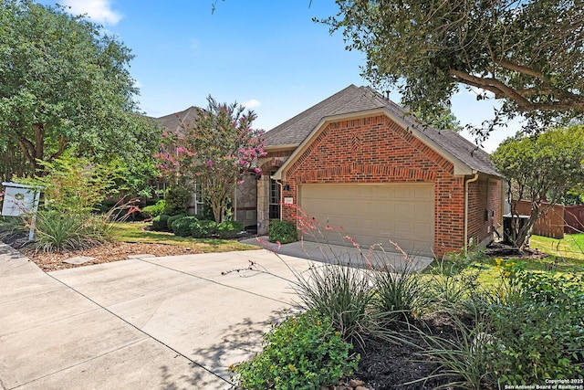 23407 Treemont Park, San Antonio, TX 78261 - view of front of home featuring brick siding, a garage, a shingled roof, and concrete driveway