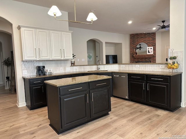 23407 Treemont Park, San Antonio, TX 78261 - kitchen with stainless steel dishwasher, dark cabinets, arched walkways, ceiling fan, and recessed lighting