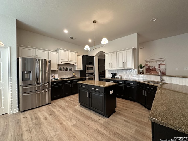 23407 Treemont Park, San Antonio, TX 78261 - kitchen with stainless steel appliances, dark cabinets, and white cabinetry