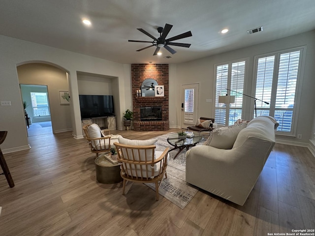 23407 Treemont Park, San Antonio, TX 78261 - living area featuring arched walkways, ceiling fan, wood finished floors, recessed lighting, and a brick fireplace