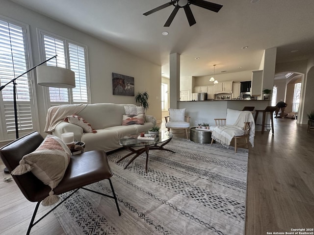 23407 Treemont Park, San Antonio, TX 78261 - living area featuring healthy amount of natural light, ceiling fan, wood finished floors, arched walkways, and recessed lighting