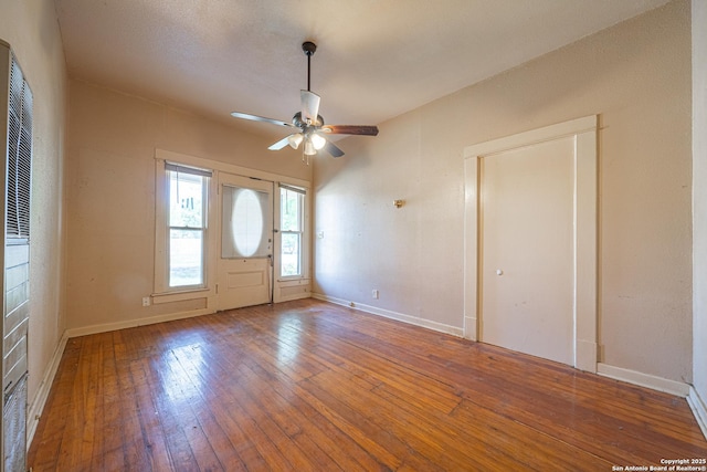 entryway with baseboards, hardwood / wood-style floors, and ceiling fan