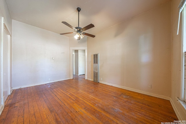 empty room with baseboards, a ceiling fan, and hardwood / wood-style flooring