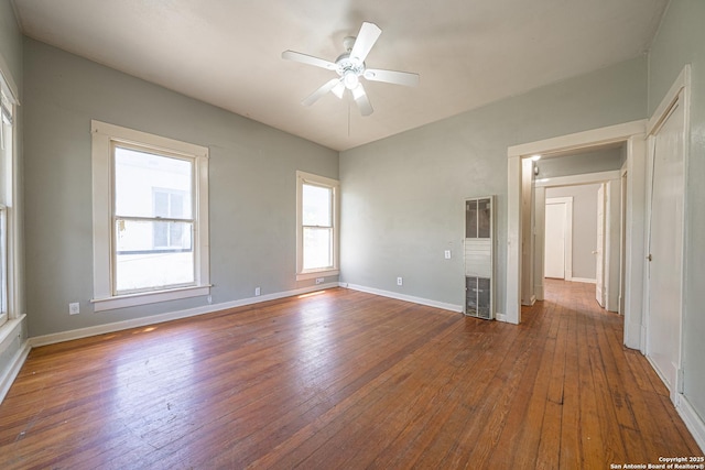 unfurnished room with baseboards, hardwood / wood-style floors, and ceiling fan