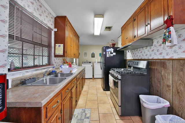 307 Trudell, San Antonio, TX 78213 - kitchen featuring visible vents, under cabinet range hood, independent washer and dryer, stainless steel gas range oven, and light tile patterned flooring