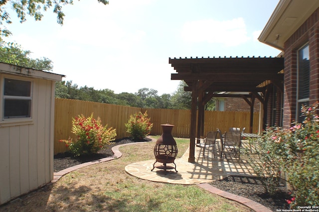 24323 Flint Crk, San Antonio, TX 78255 - view of yard with a pergola, fence private yard, a patio area, and an outdoor fire pit